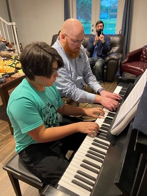 Playing piano with youth at Weygant Law.jpg